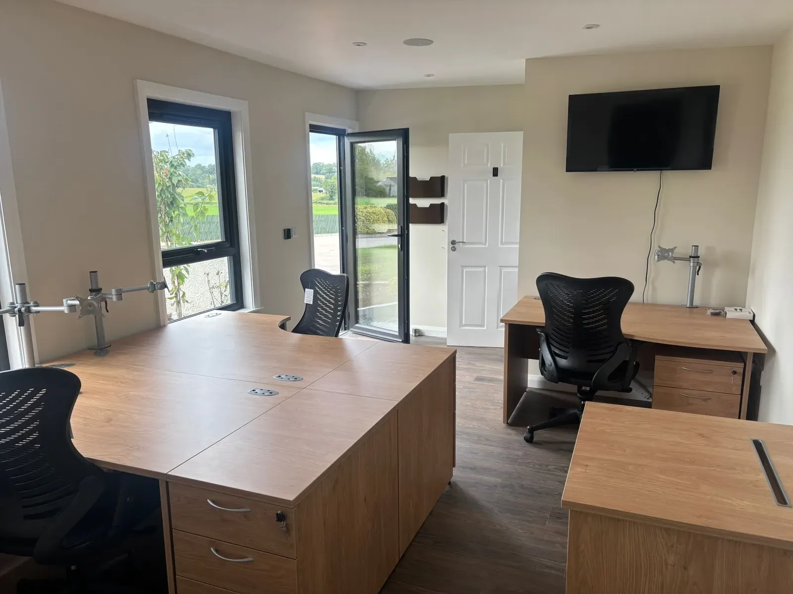 Garden office interior with desks and natural light